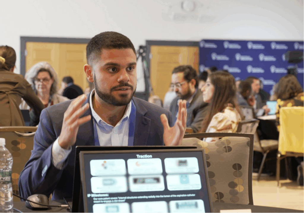 man pitching in front of computer